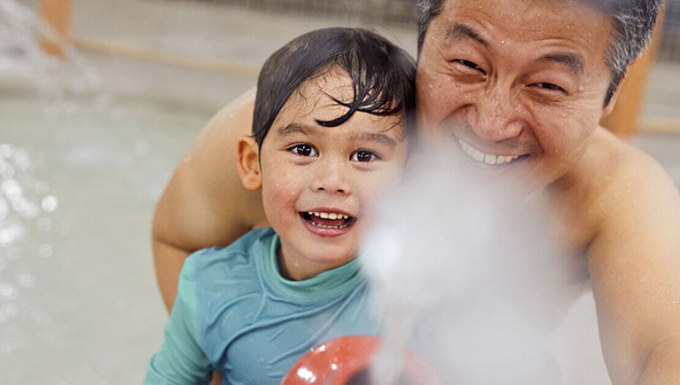 Dad with son in water park