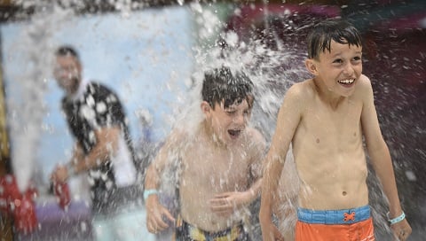 Two brothers splash in the water 