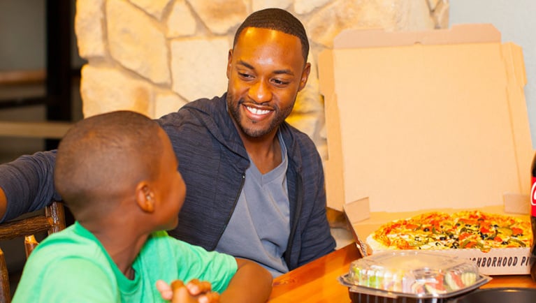 A father and son dine at Northwoods Pizza Company at Great Wolf Lodge indoor water park and resort..