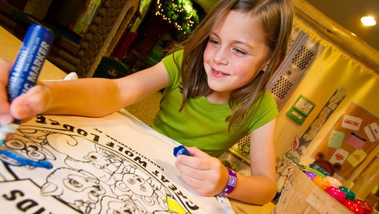 A girl uses markers to color at Great Wolf Lodge indoor water park and resorts.