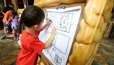 A young child draws at an event at Great Wolf Lodge indoor water park and resorts.
