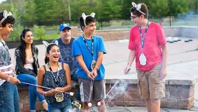 A family roasts s'mores outdoors