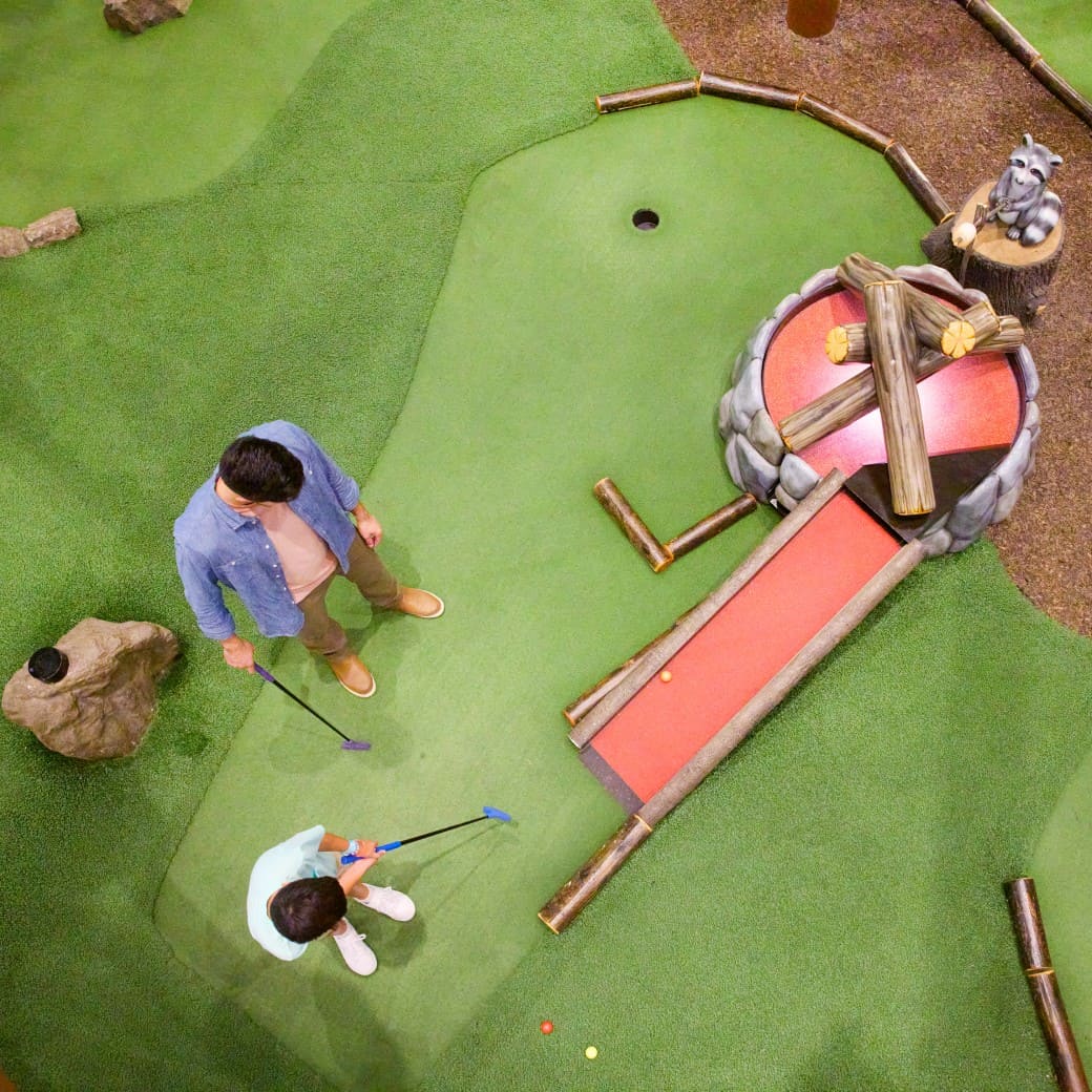 Family play a round of mini golf