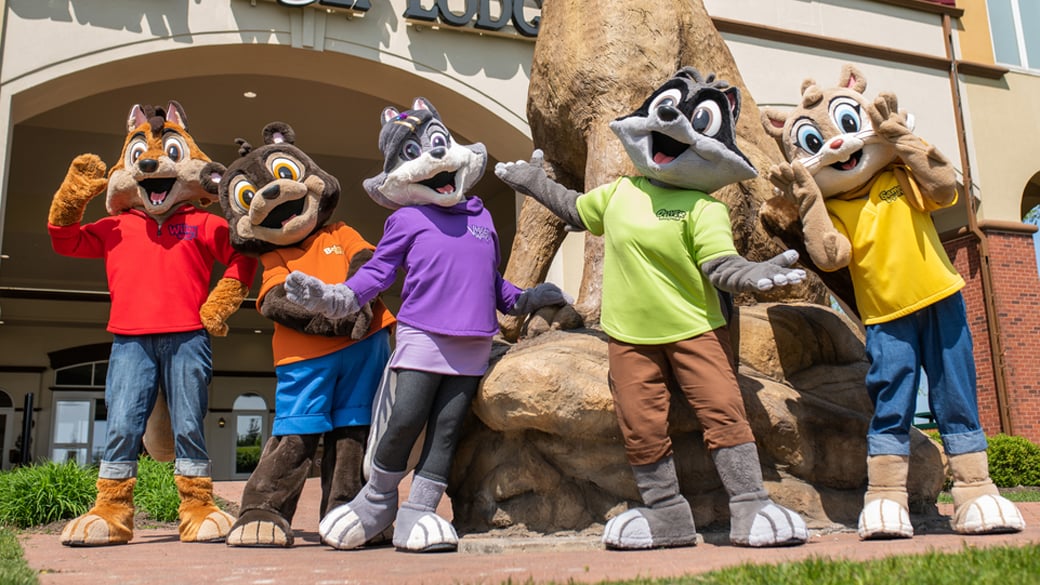 Great wolf lodge characters in front of a lodge