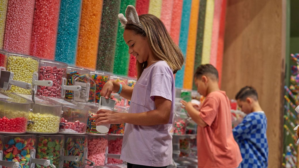 two girls looks at the candy towers.