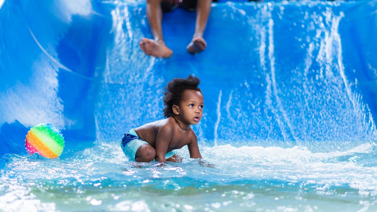toddler playing in a kiddie pool