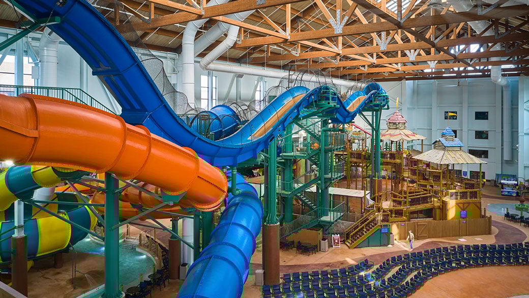 view of the indoor water park with orange and blue slides
