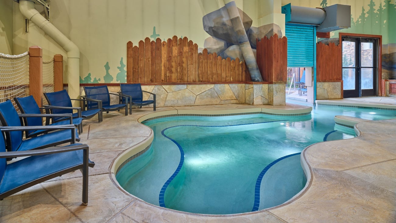 A family of four relaxes in the indoor pool