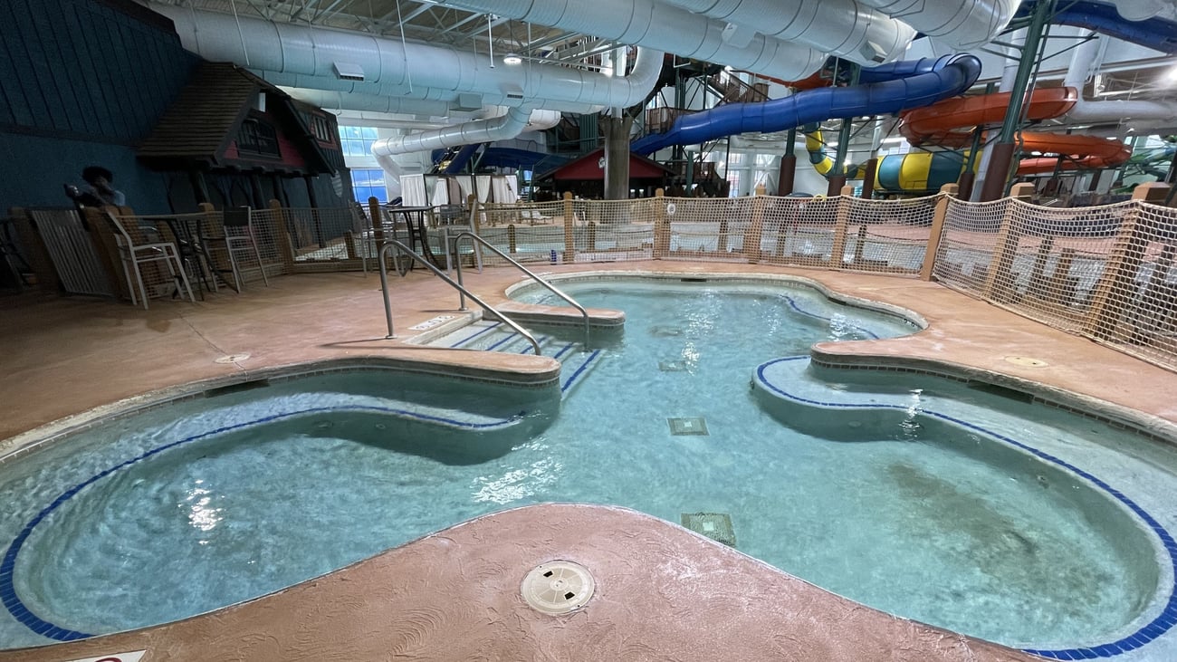 A family of four relaxes in the indoor pool