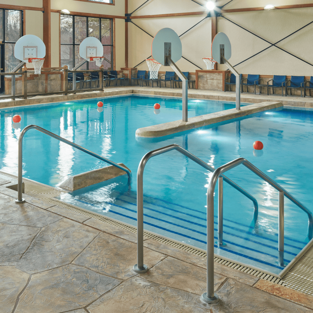 A spacious indoor pool featuring a large slide and multiple water slides for recreational enjoyment.