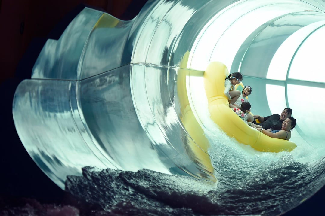 Family of five rides down enclosed waterslide 