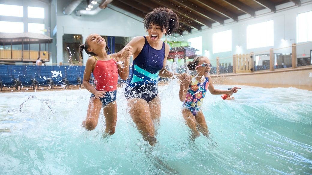 Mother with her two children enjoying in the waterpark