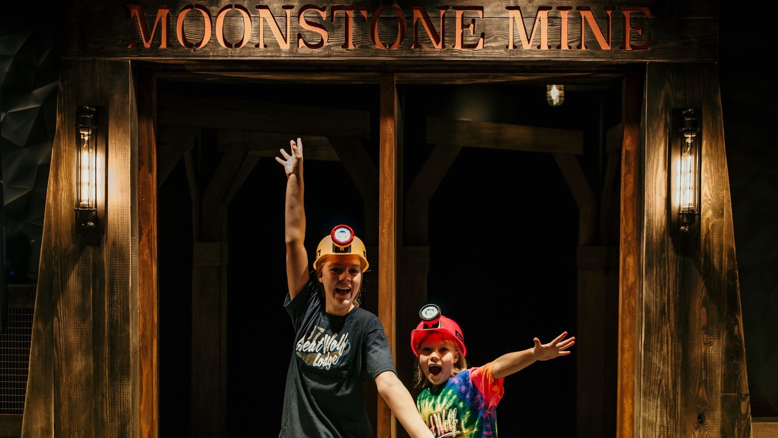 Two kids posing excitedly in front of Moonstone Mine