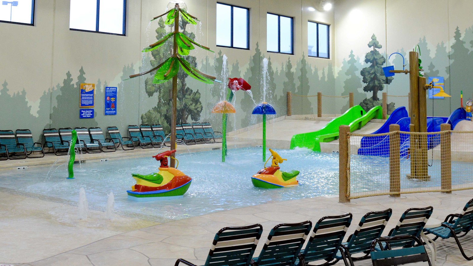 A large indoor water park featuring multiple water slides