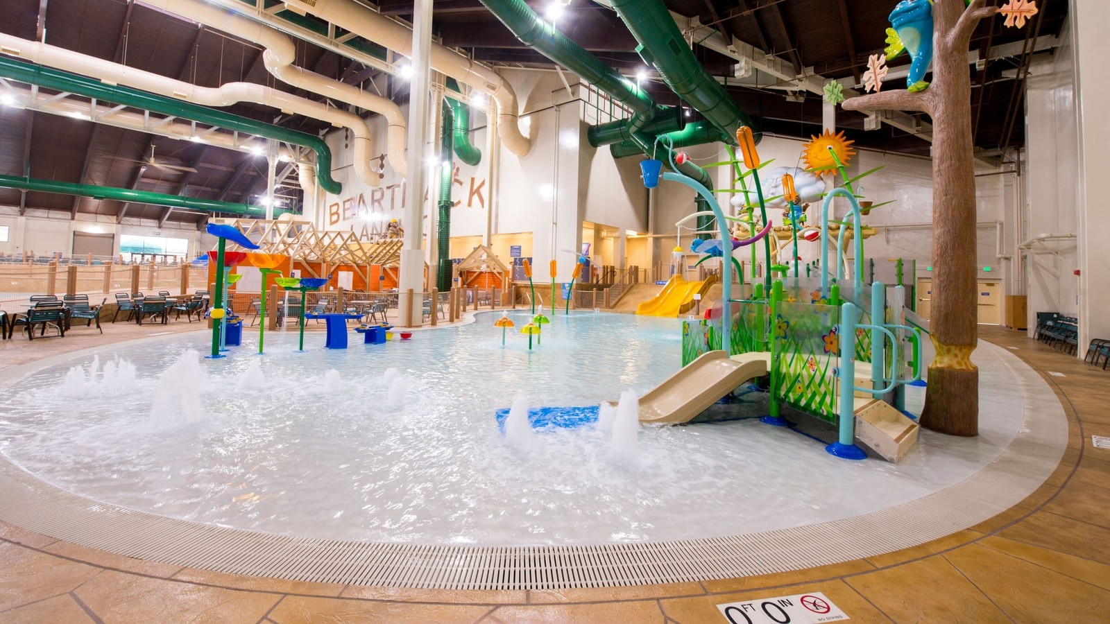 A vibrant water park featuring a large slide and a fun water play area for children.