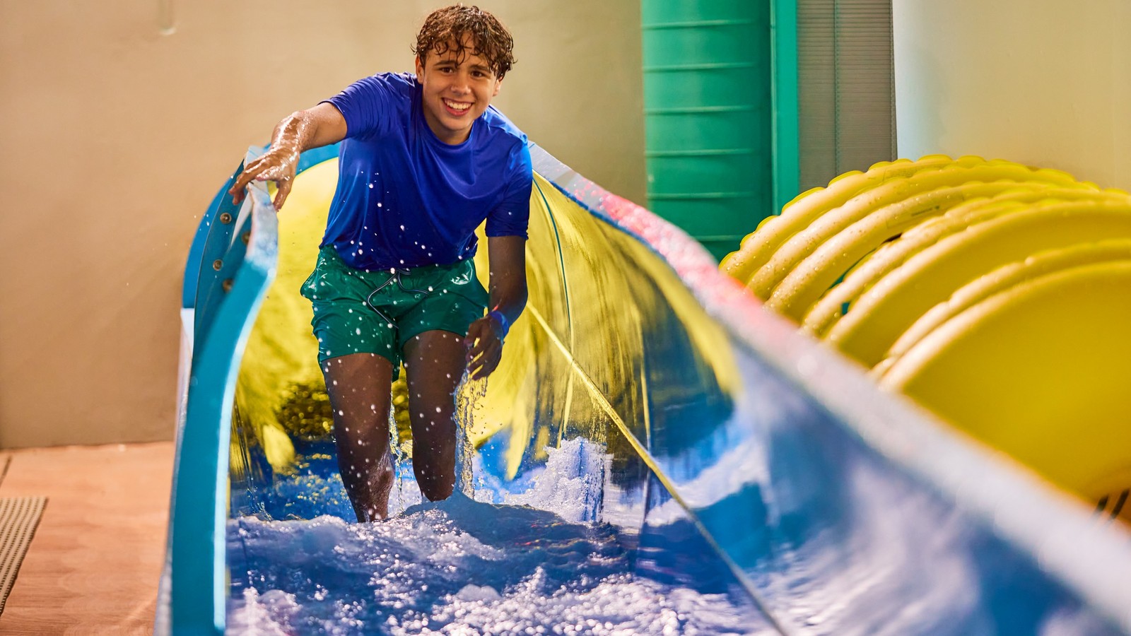 Teen going down a body water slide