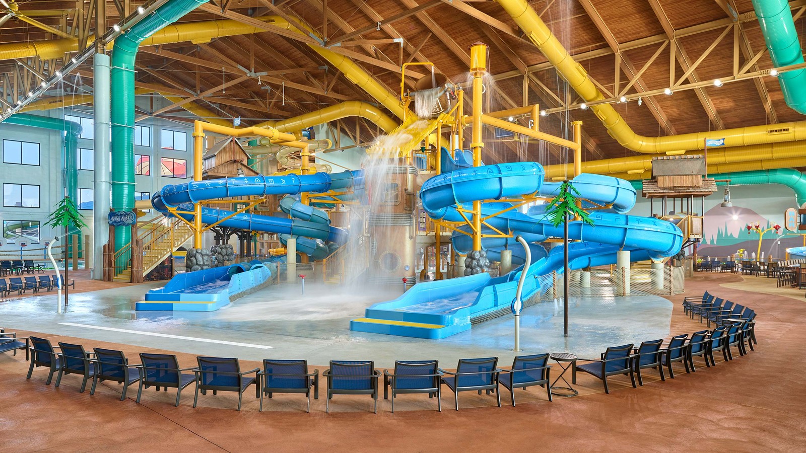 Water park fort with multiple slides and water bucket