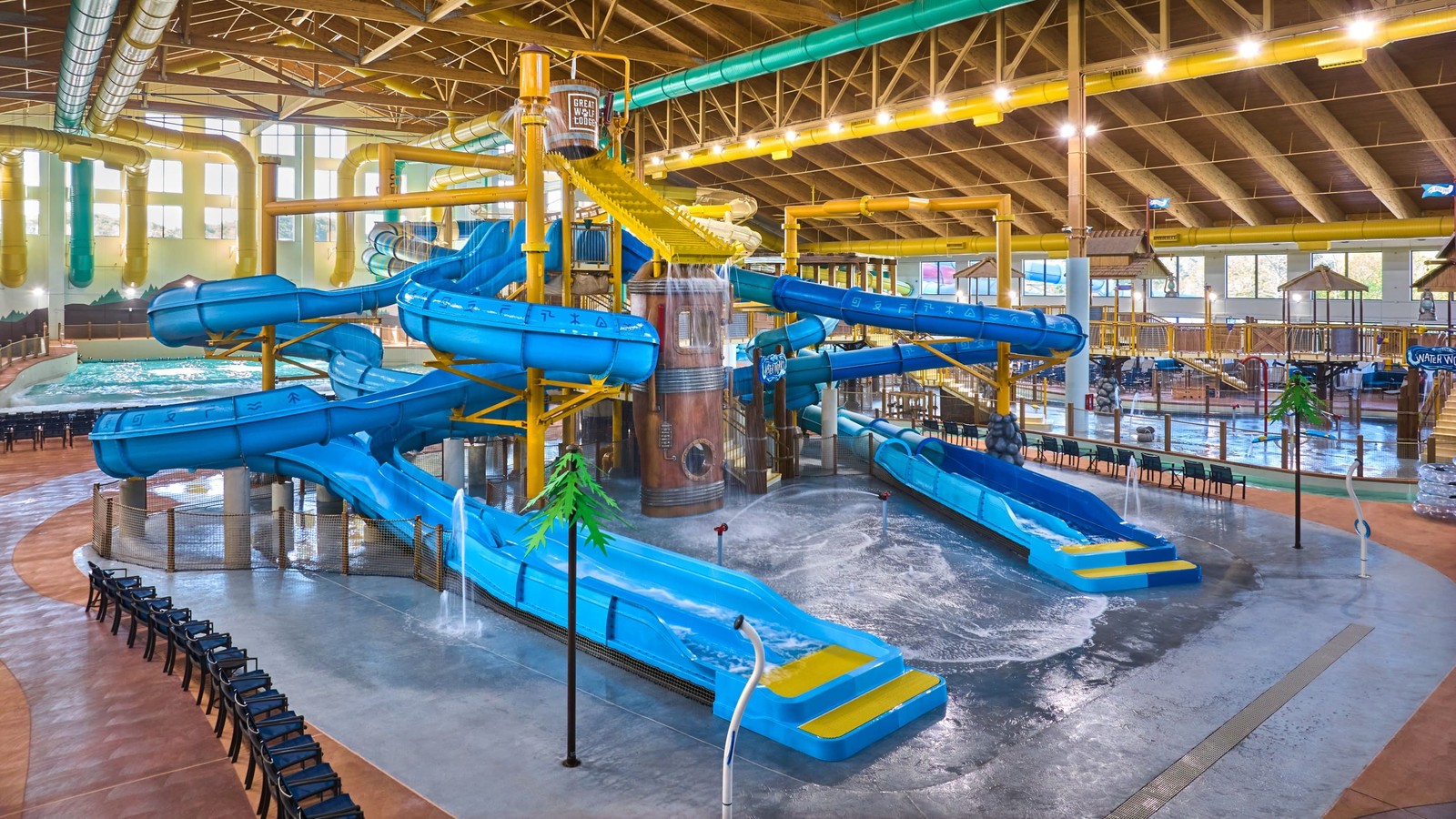 Water park fort with multiple slides and water bucket