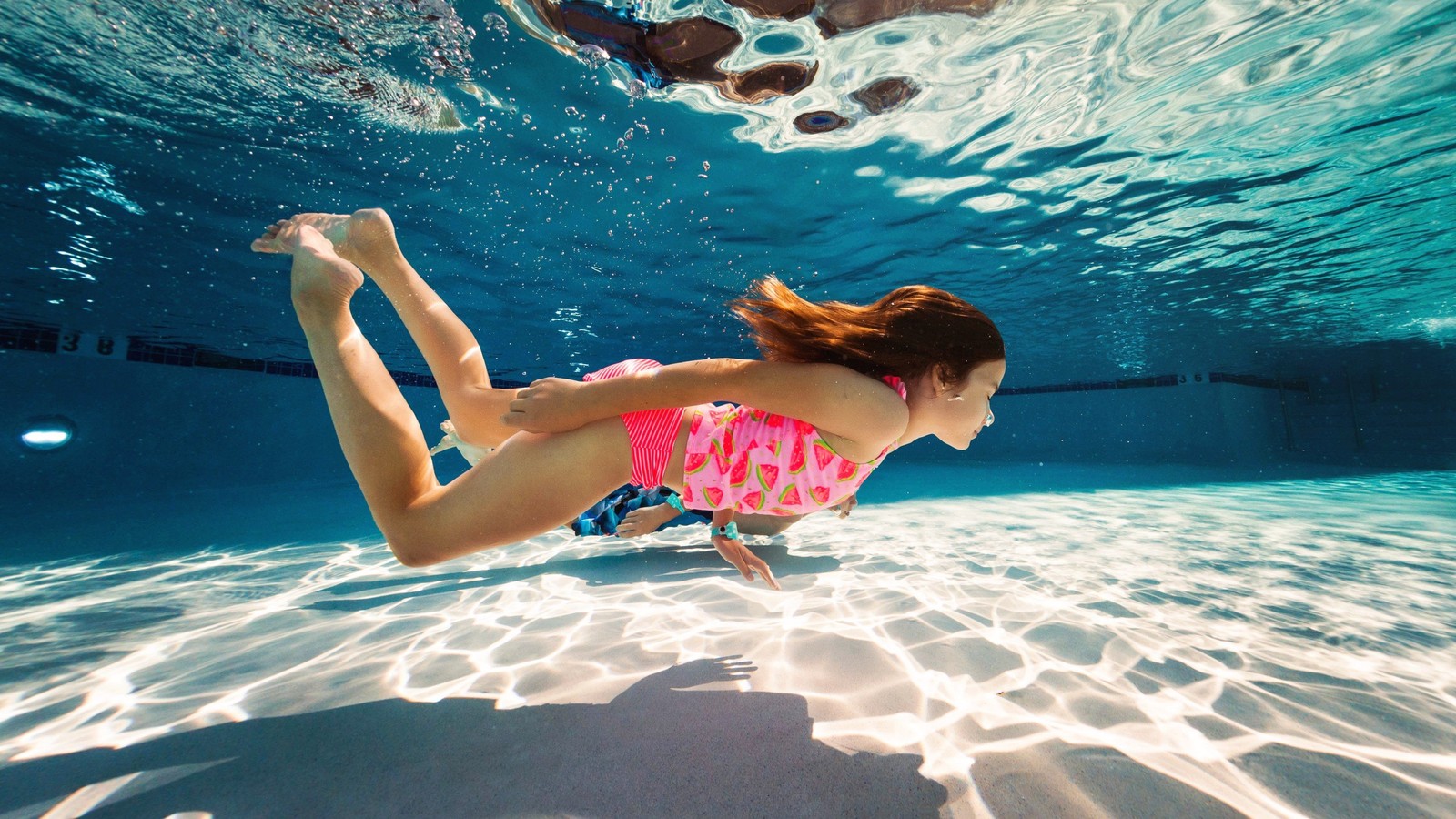 girl swimming under water