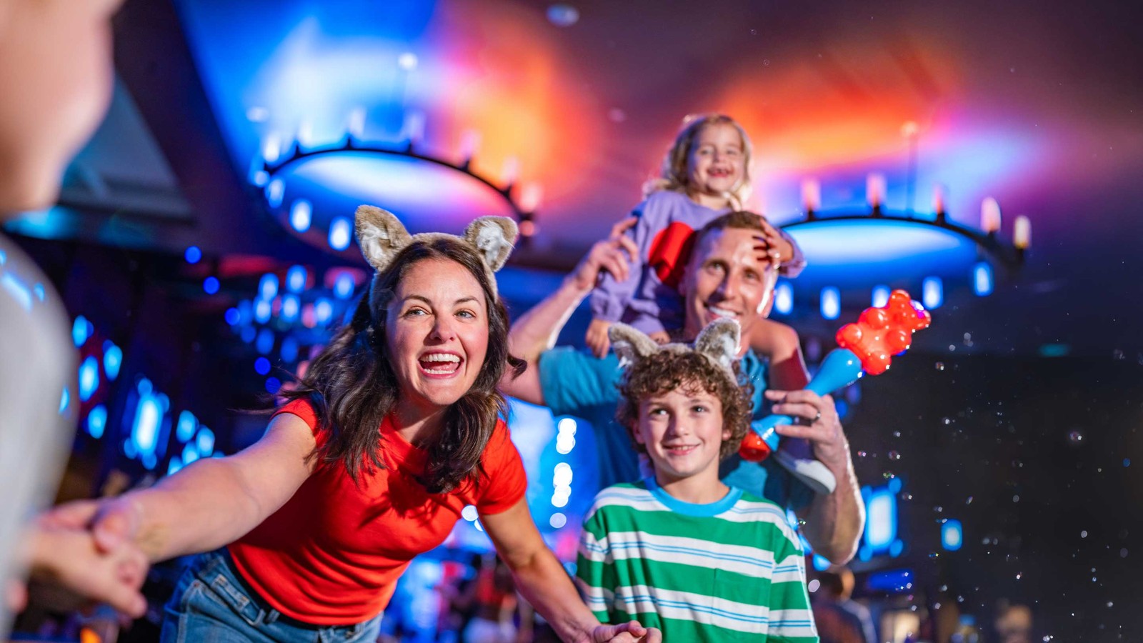 family laughing and clicking selfie at a dance party event