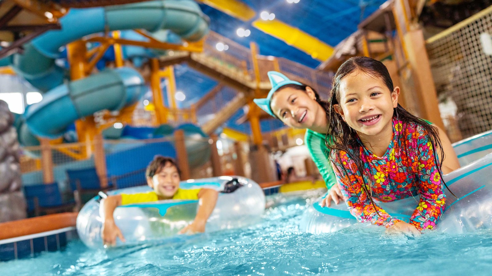 Family enjoying slow moving river riding tubes at a waterpark