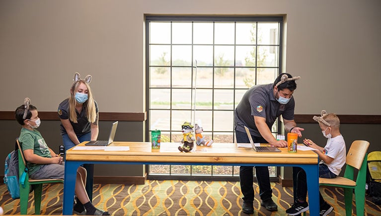 A group of kids are lead by Great Wolf Lodge employees in e-learning at Great Wolf Lodge indoor water park and resort.