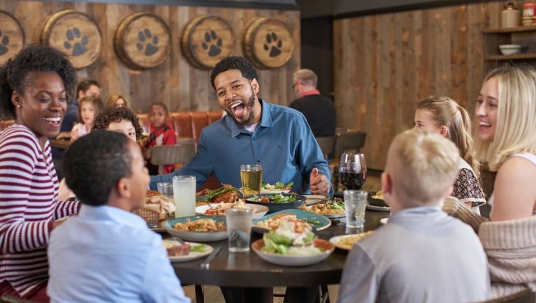 Family laughing while eating dinner