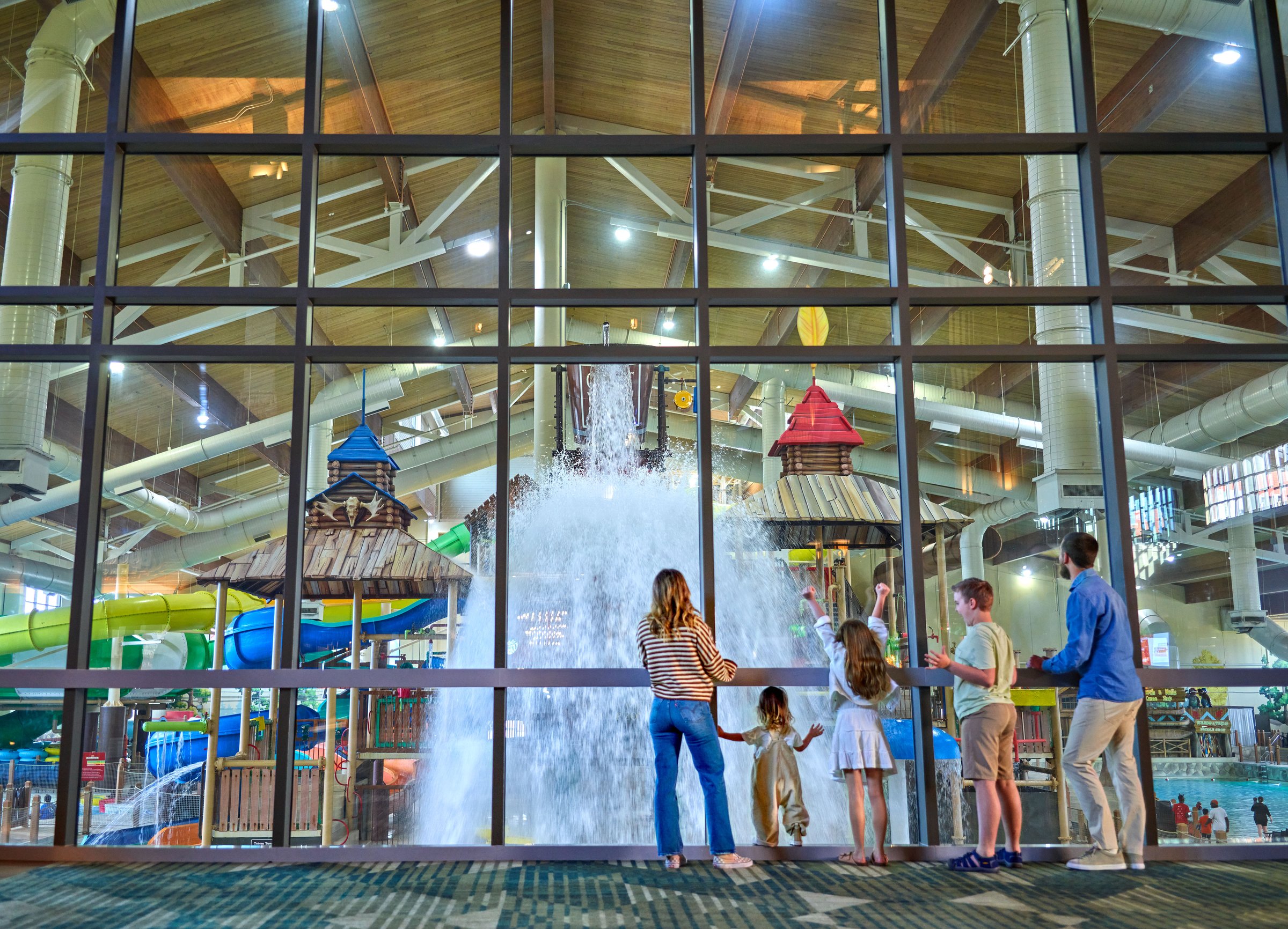 family watching water falling from a big bucket 