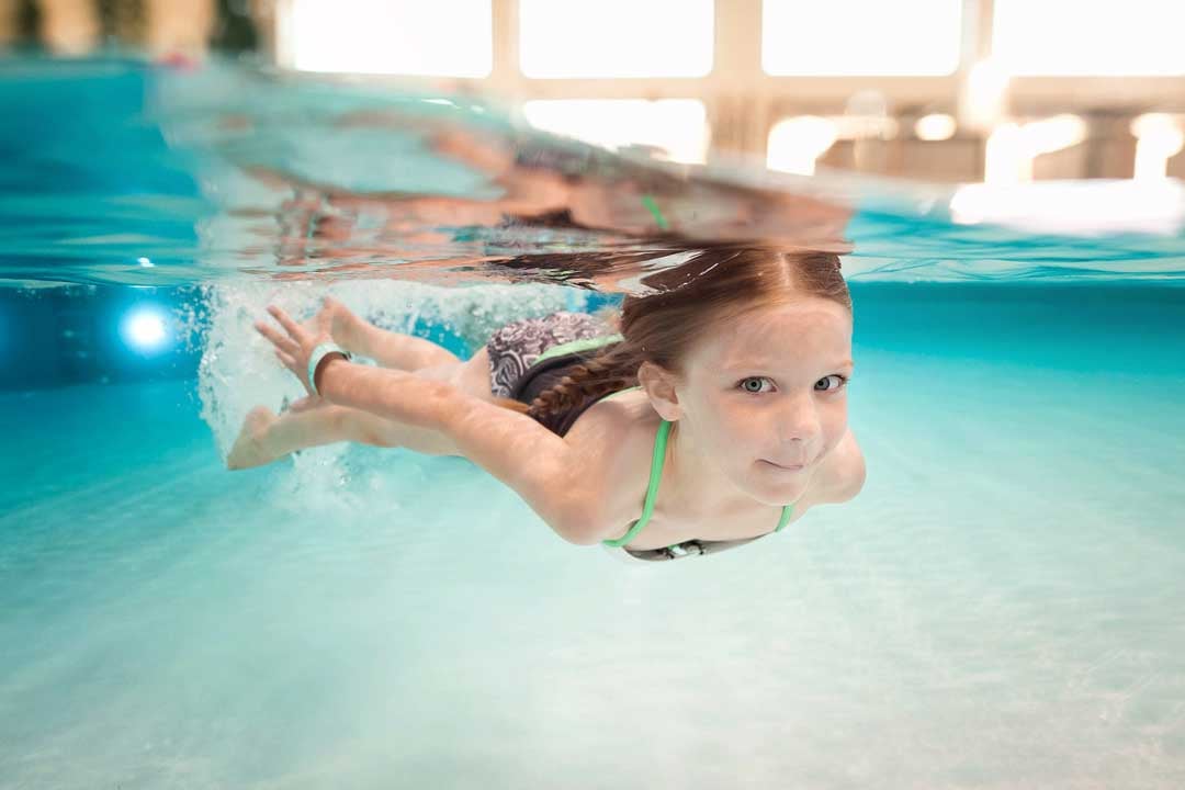 little girl swimming in the pool 