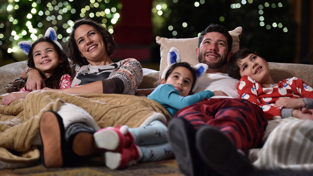 family laying on the couch Snowland family package
