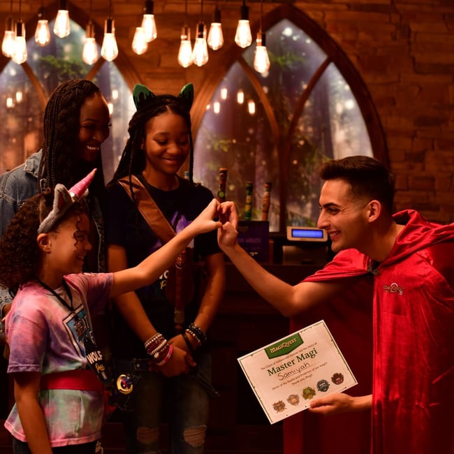 kid being awarded a master magi certificate