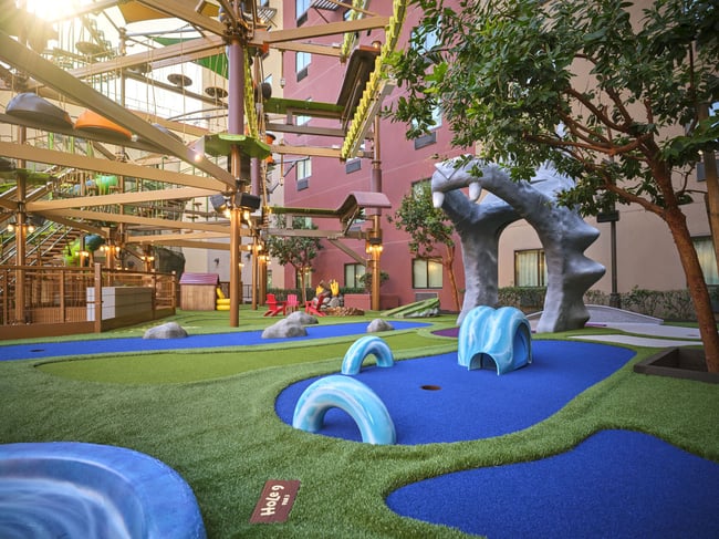 Overhead shot of a family playing mini golf