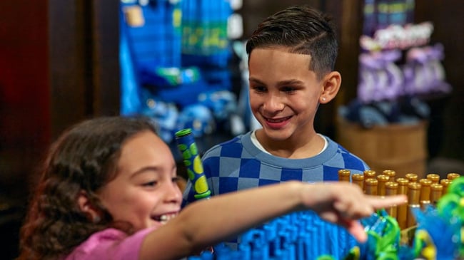 two kids in the magiquest store