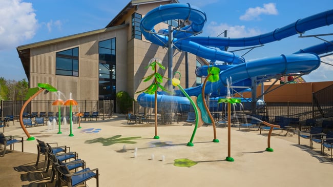 Kids play behind the outdoor water features 