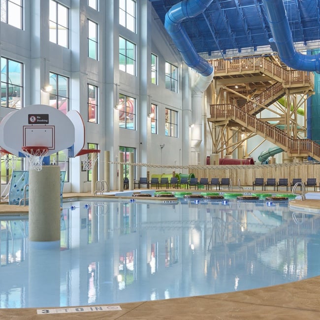 A large indoor pool equipped with a colorful water slide