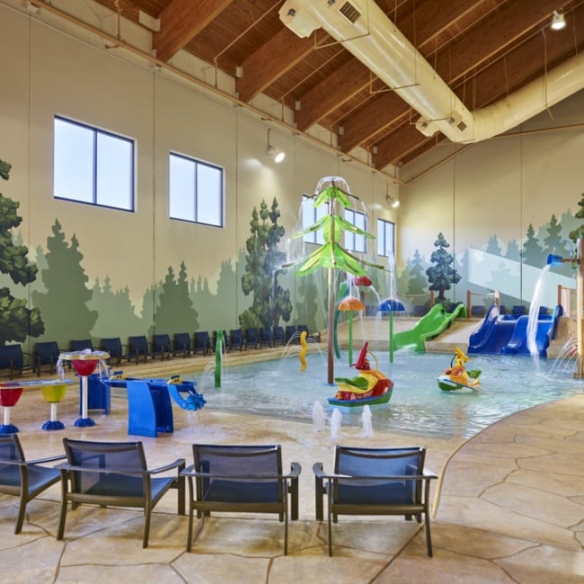 mother and child playing in a kiddie pool