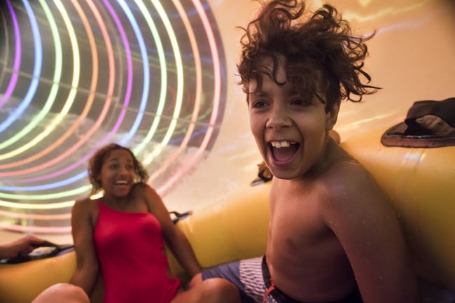 A family rides the Diamond Back Drop water slide