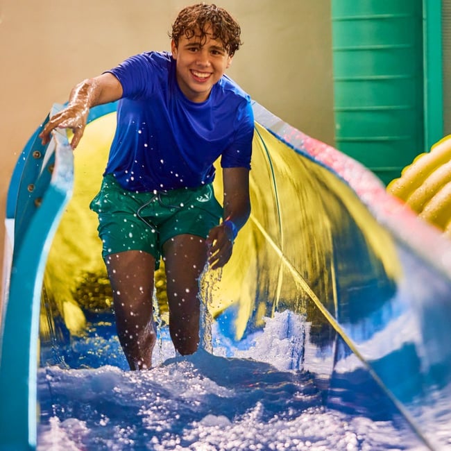 Teen enjoying water slide adventure ride