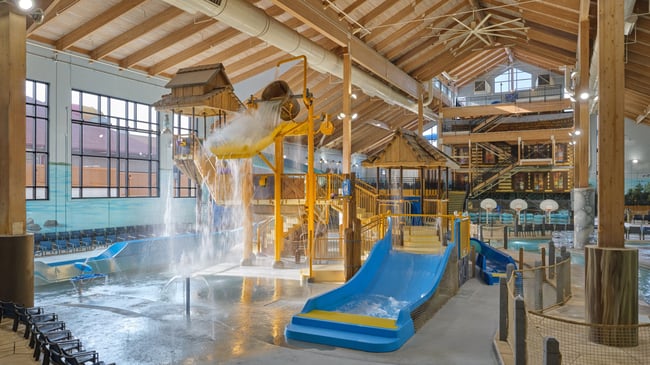 A wide shot of the water treehouse as water splashes down from a bucket