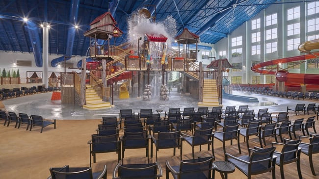 A wide shot of the water treehouse as water splashes down from a bucket