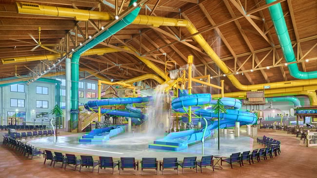 A wide shot of the water treehouse as water splashes down from a bucket