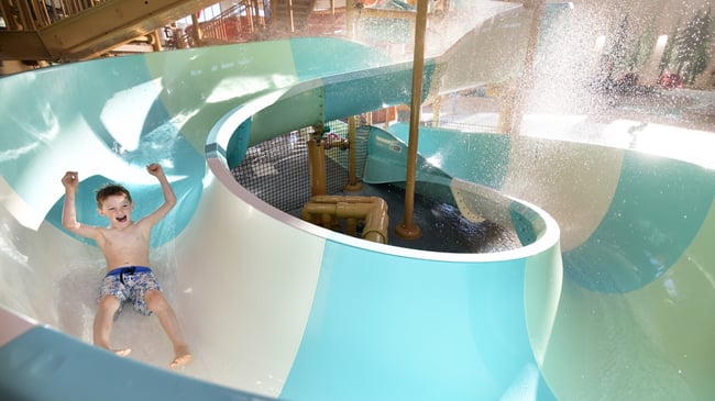 kid rides down waterslide