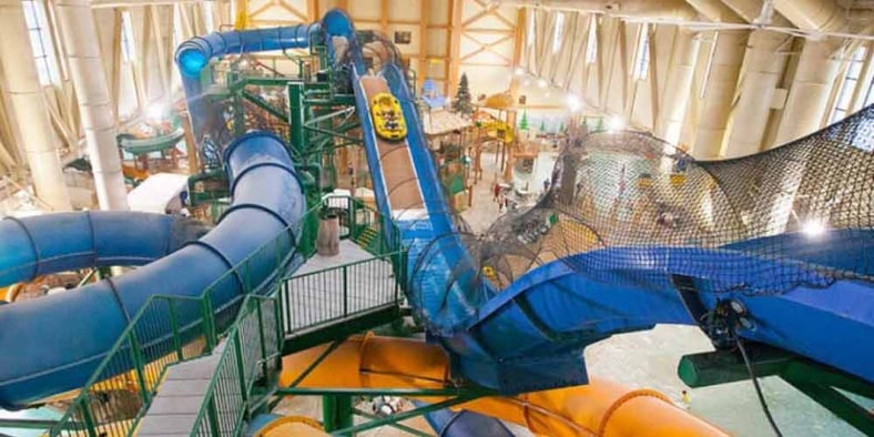 Wide view of the Niagara Rapids Run's multiple tube slides at Great Wolf Lodge indoor water park and resort.