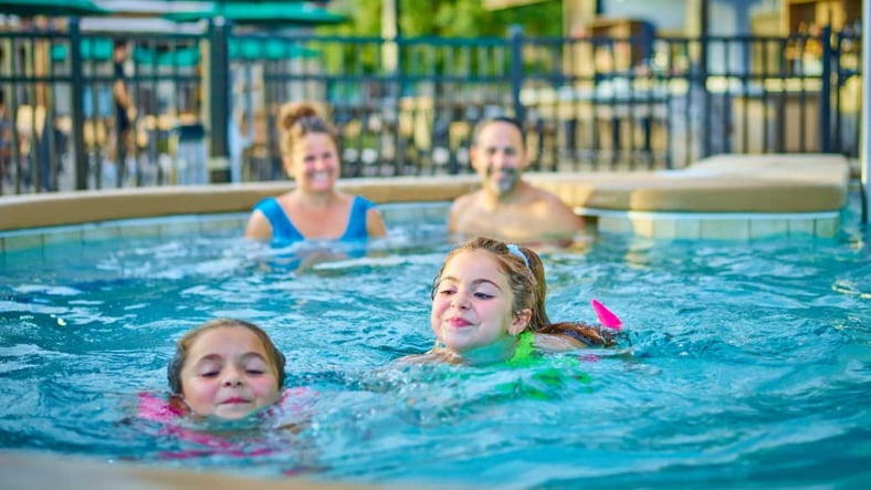Kids and family having fun in pool