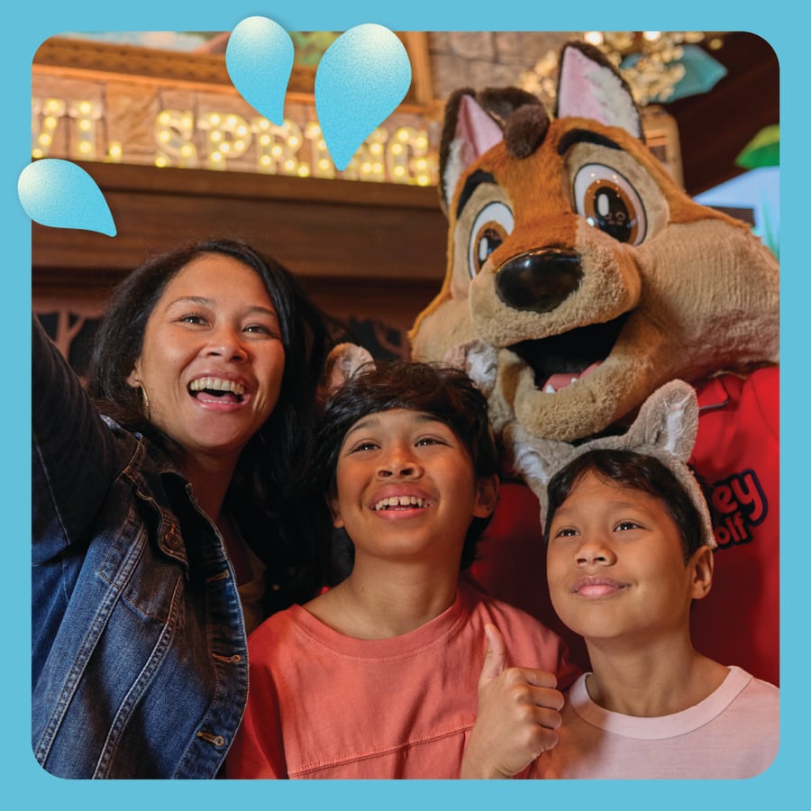Family clicking a picture with Great Wolf Character