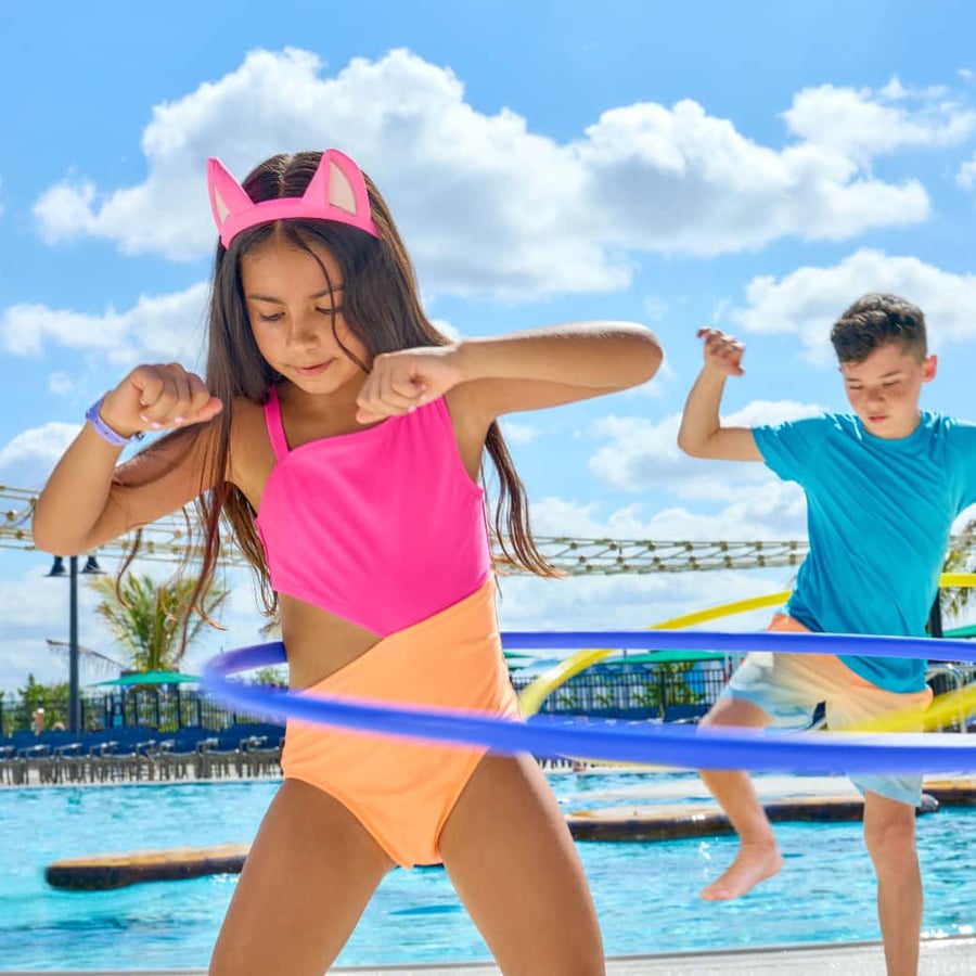 kids playing with hula-hoop near a pool