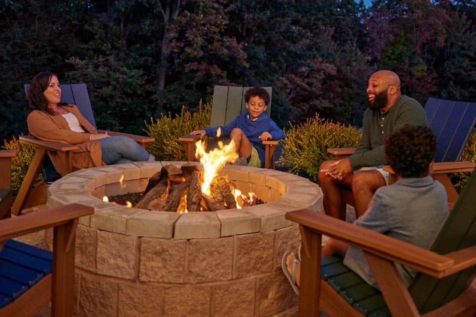 family sitting near firepit