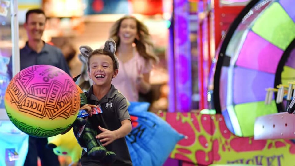 family enjoying arcade games