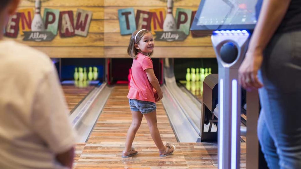little girl playing bowling