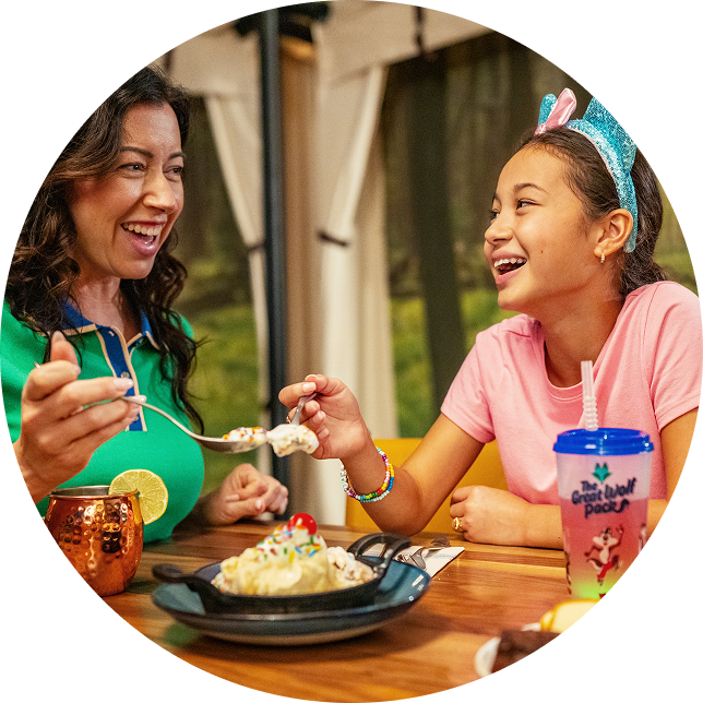 mother and daughters eating dessert with whipped cream